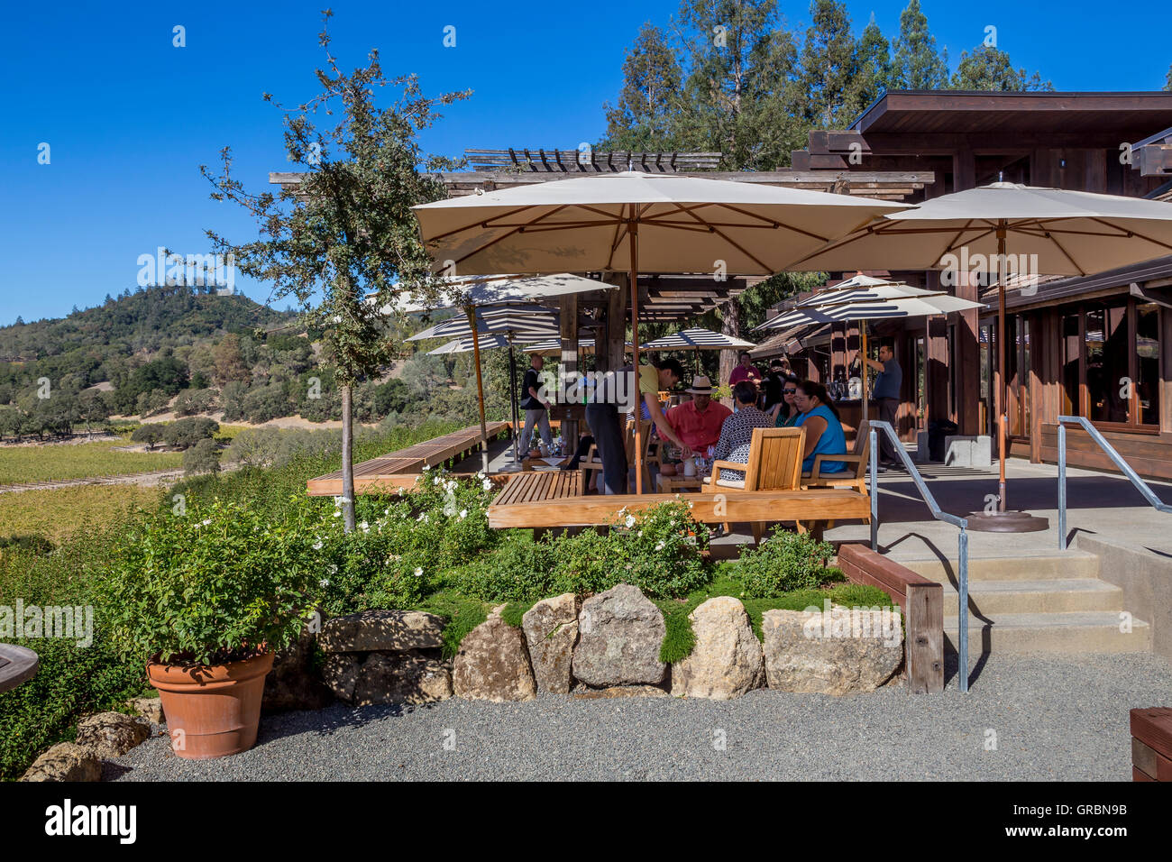 people, tourists, wine tasting, seated wine tasting, outdoor terrace, tasting room, Joseph Phelps Vineyards, Saint Helena, Napa Valley, California Stock Photo