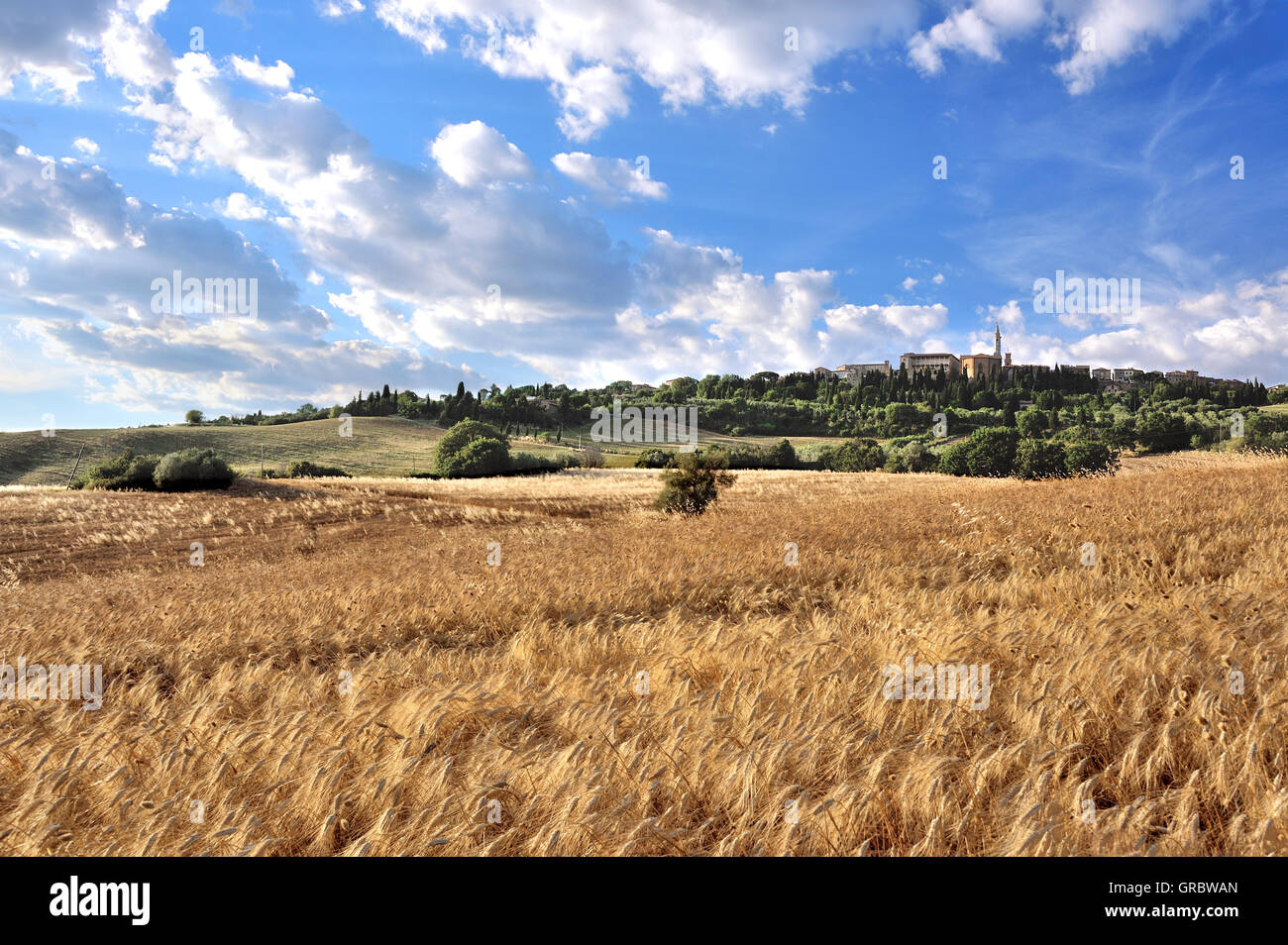 Panorama View Of Pienza On A Hill, Atmospheric Light Betwen Hills And Cornfields, Tuscany, Italy Stock Photo