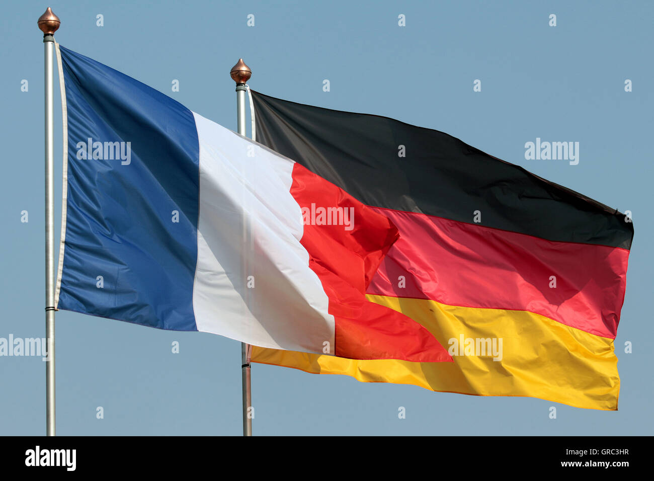 Flags Of France And Germany Blowing In The Wind Stock Photo