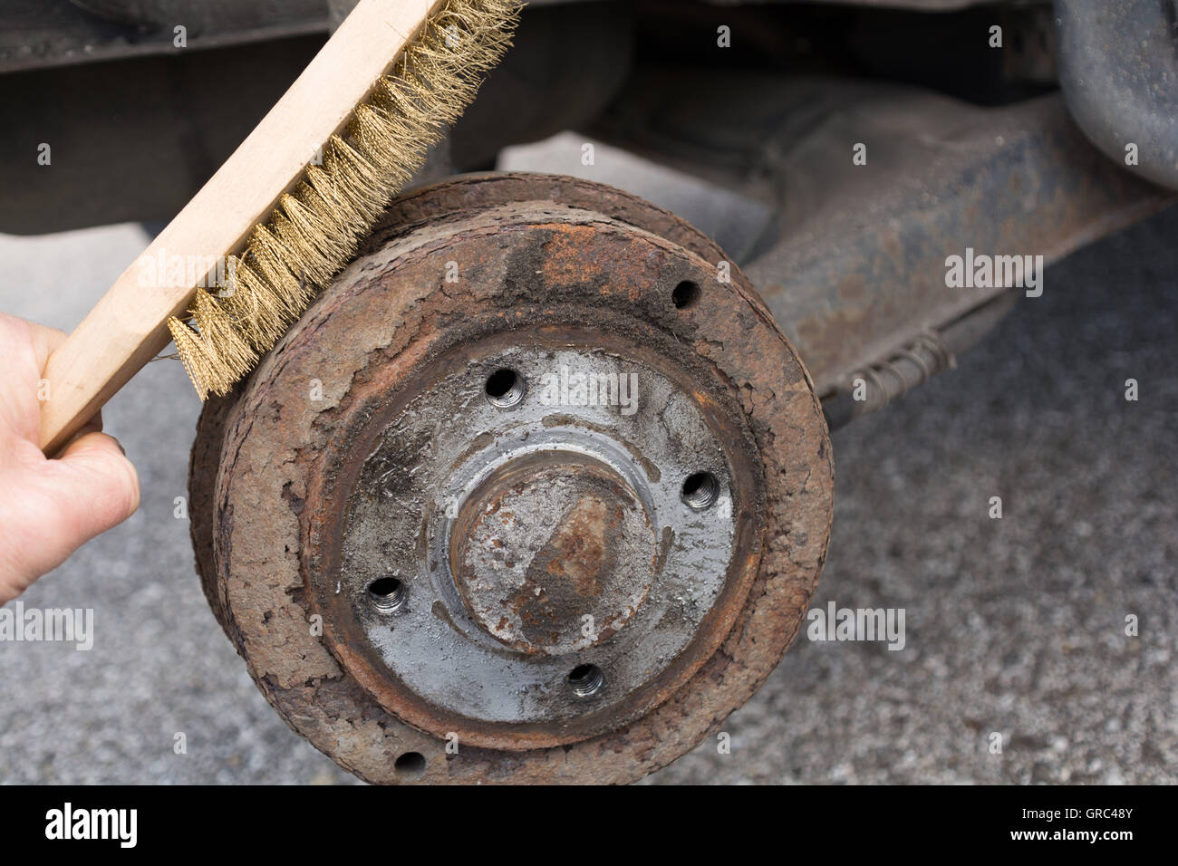 With A Wire Brush Rusted Brake Drum Is Cleaned Stock Photo Alamy