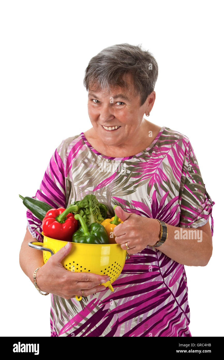 Senior Woman Presenting A Basket Of Vegetables Stock Photo - Alamy