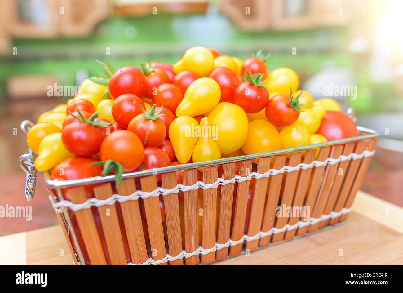Tomatoes in a basket in the kitchen. Close-up Stock Photo - Alamy