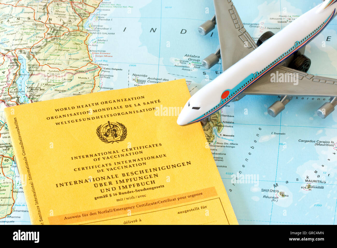 Toy Airplane With Vaccination Card On A Map Stock Photo