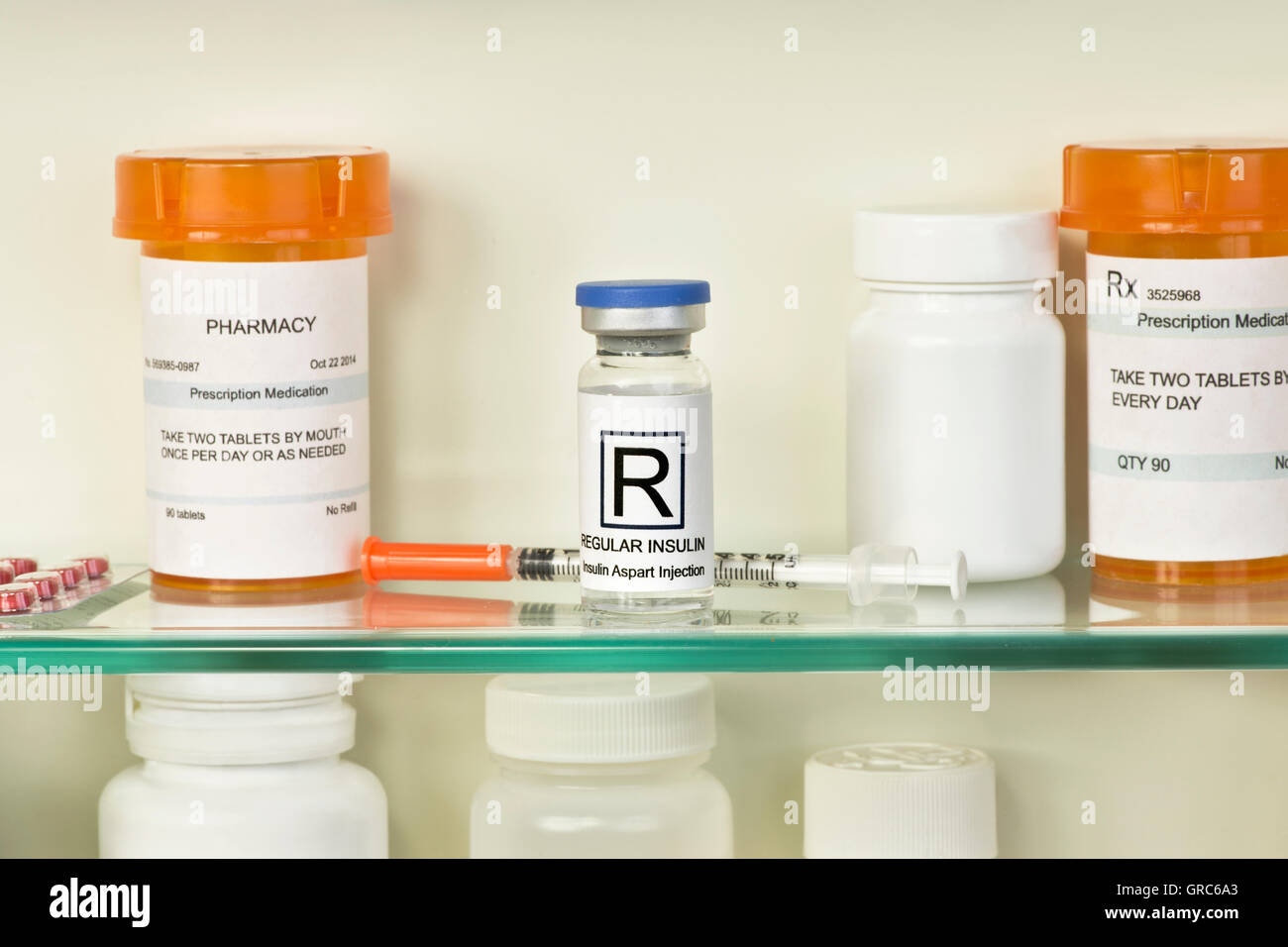 Vial Of Regular Insulin And Syringe On Medicine Cabinet Shelf