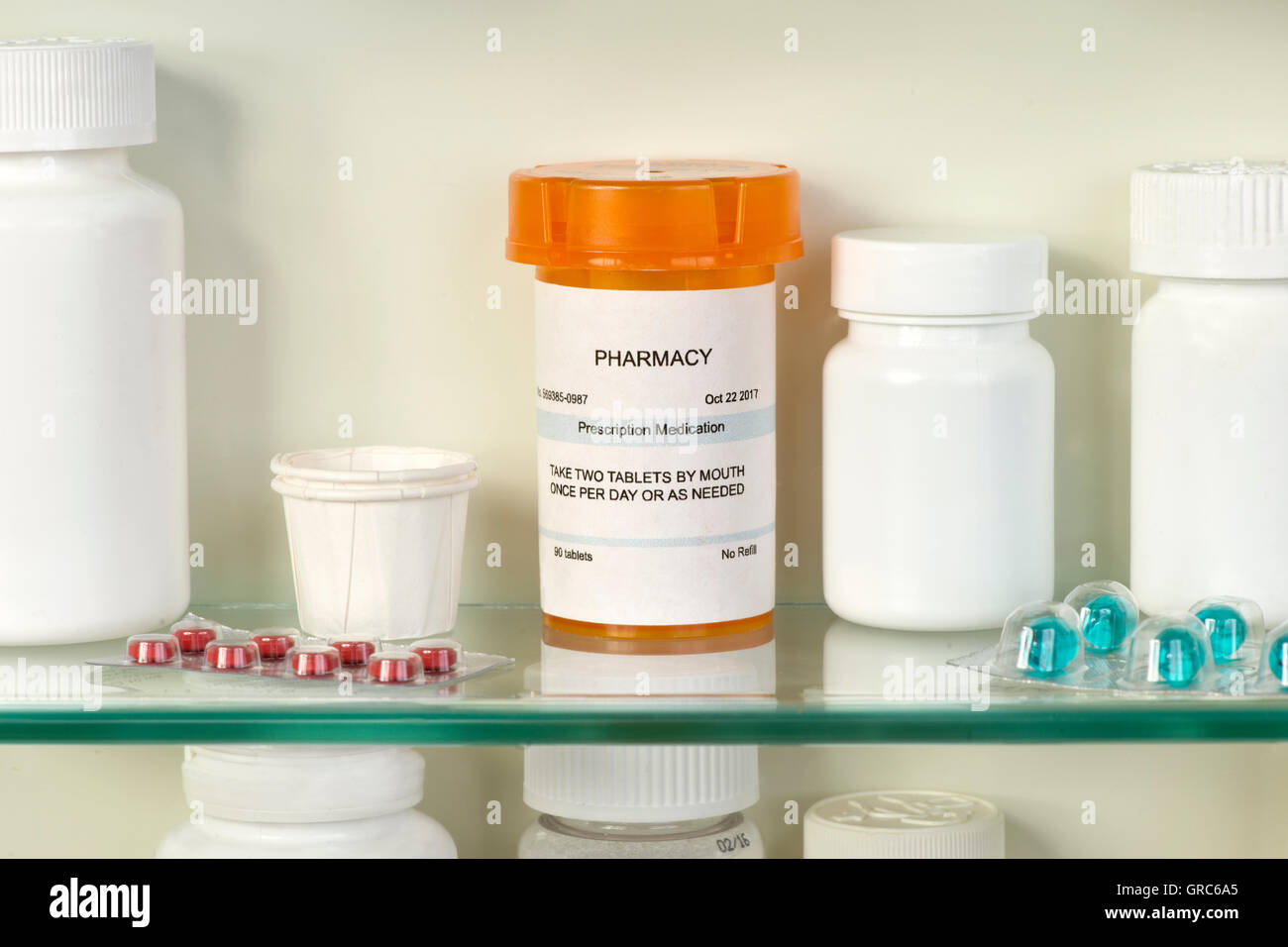 Medicine cabinet with pill bottles and syringe Stock Photo - Alamy