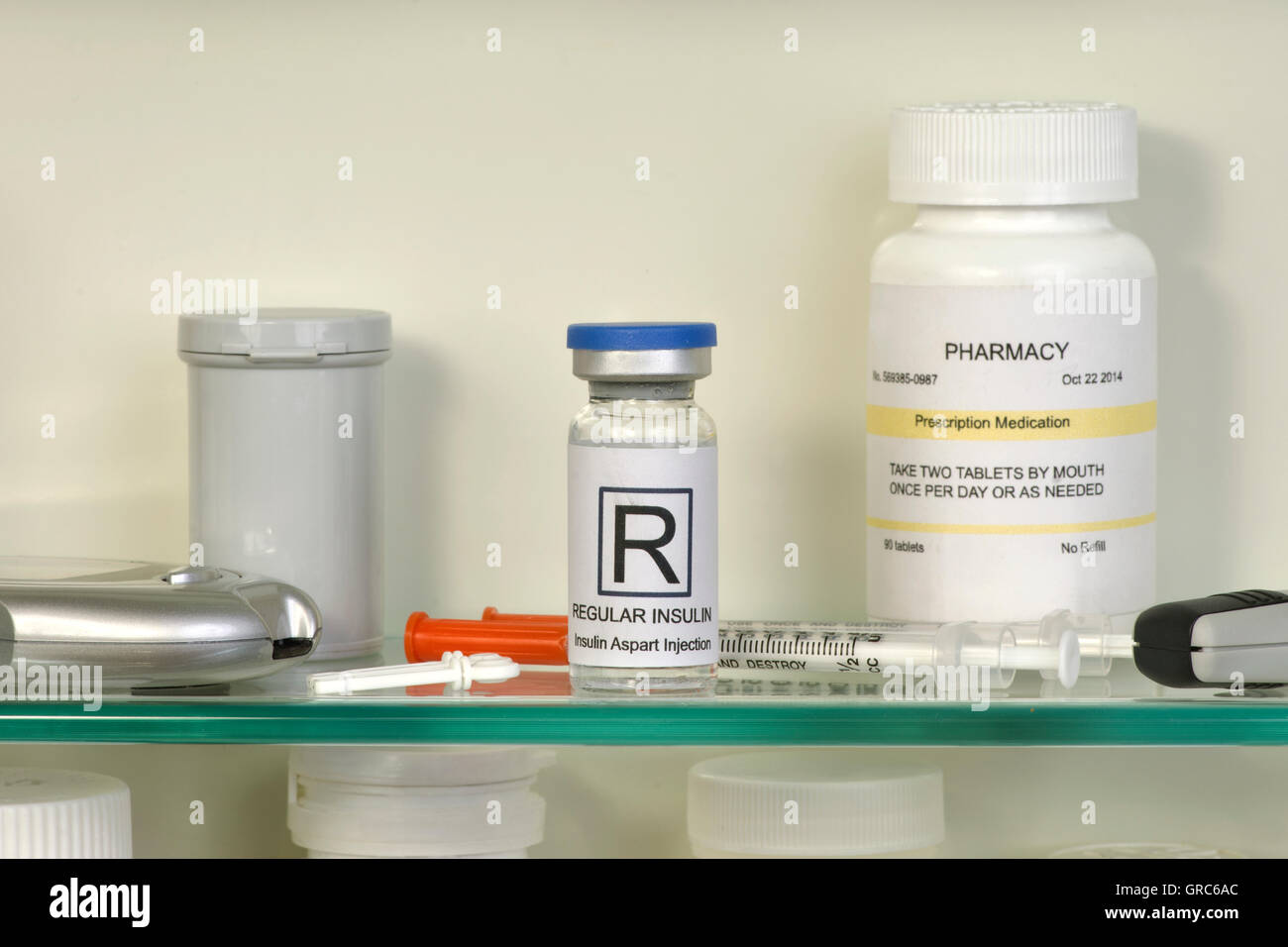 Medicine cabinet with pill bottles and syringe Stock Photo - Alamy