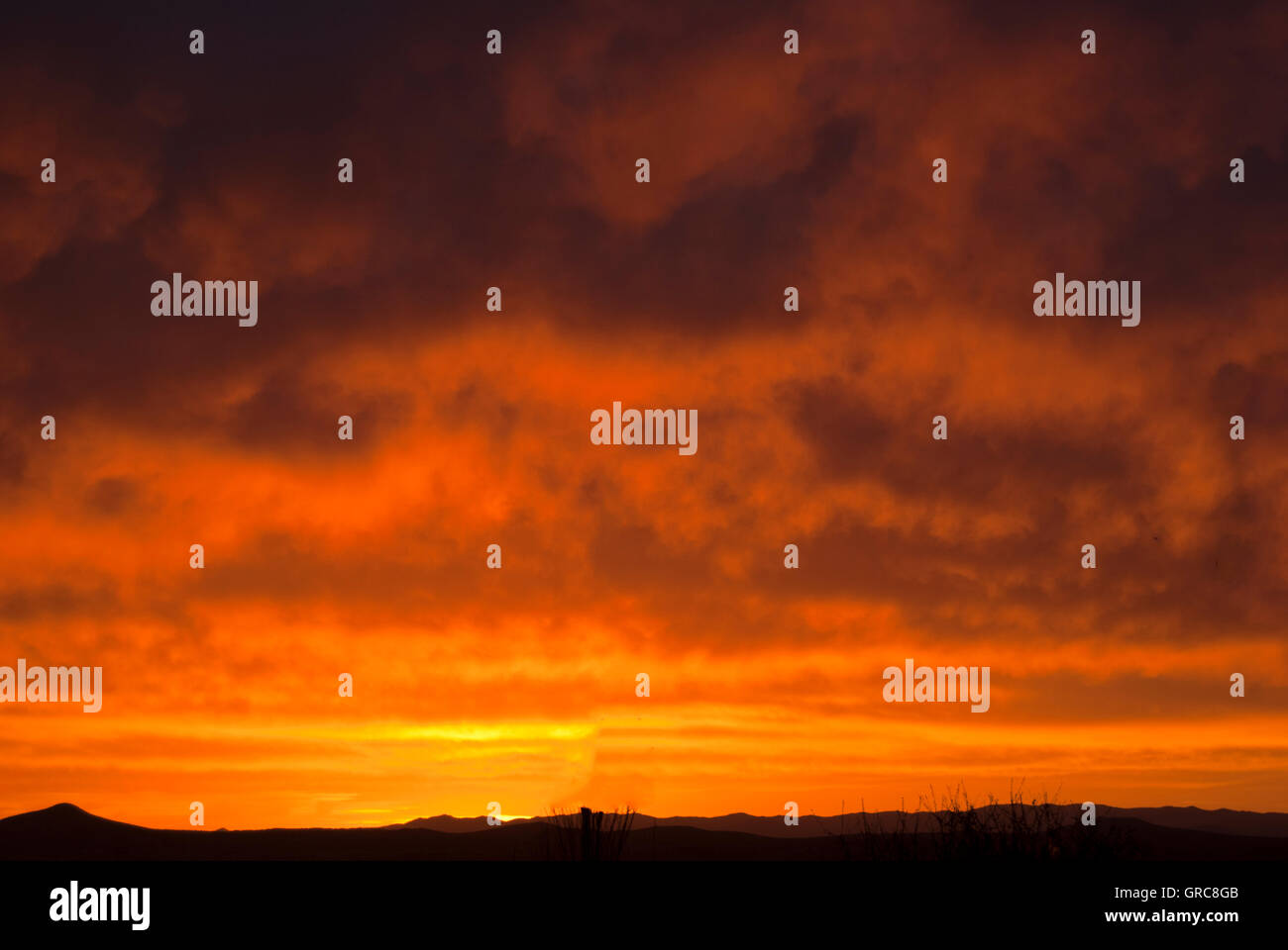 Bright red sunset over desert Stock Photo