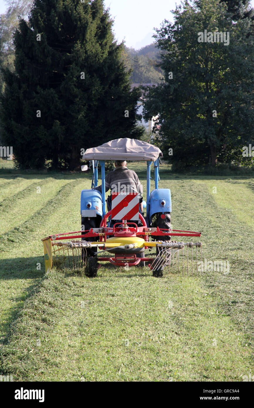 Traktor With Hay Tedder Stock Photo