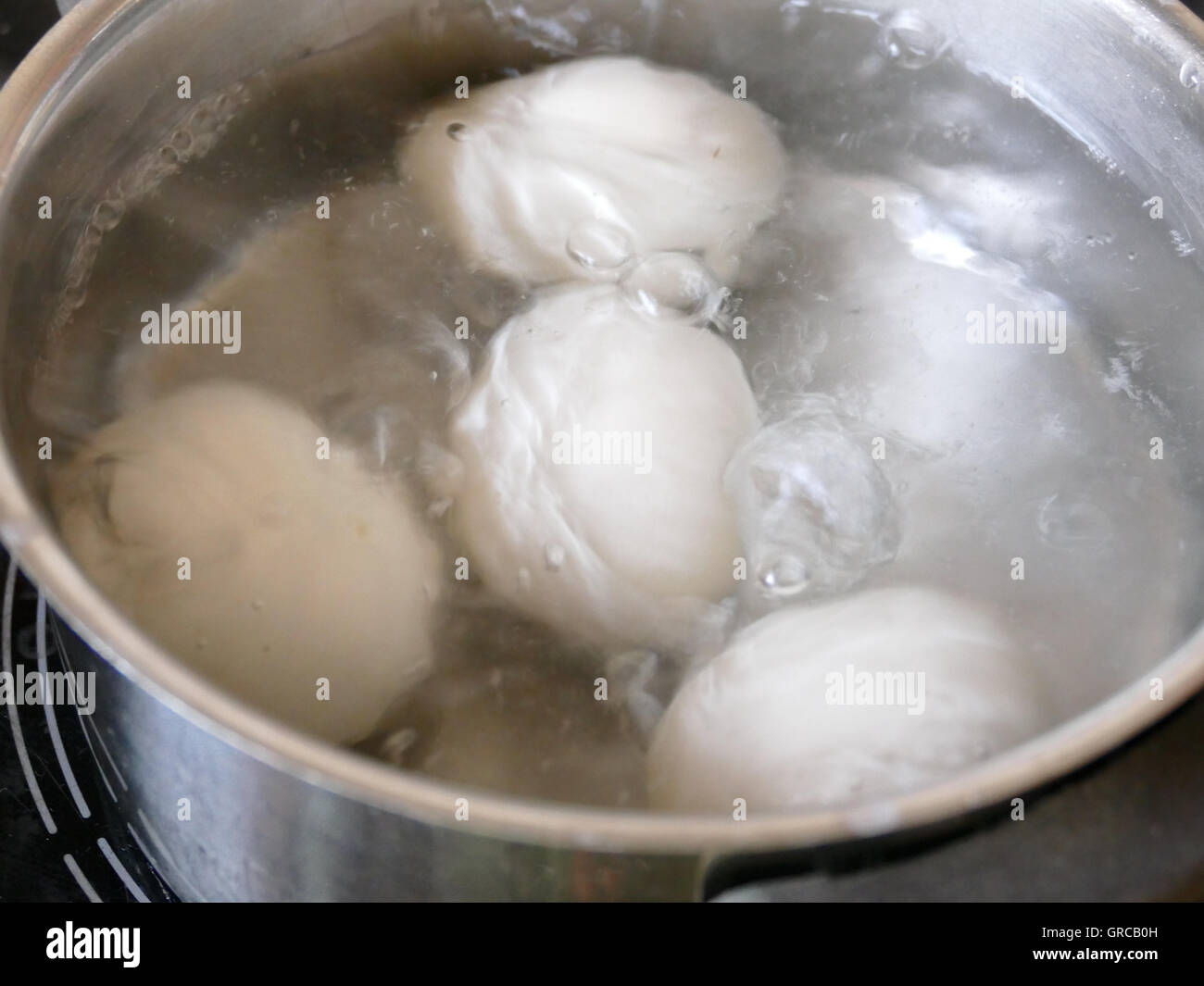 White Eggs Being Boiled In A Pot Stock Photo