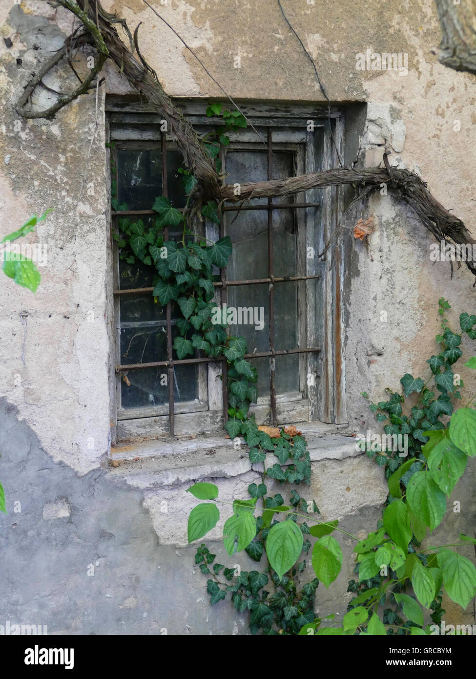Barred Window In Old Walls Stock Photo
