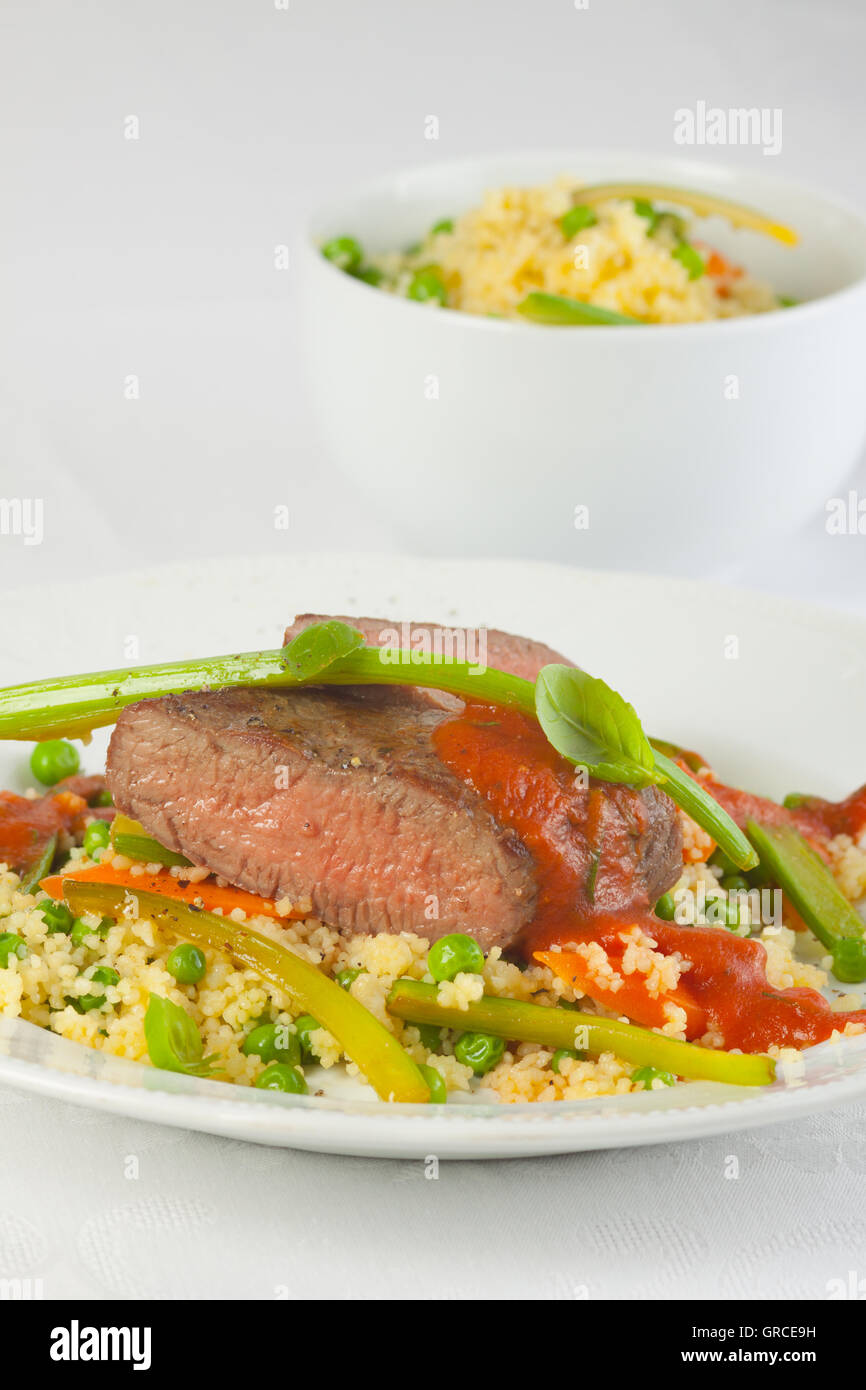 Roast Lamb With Rice And Tomato Sauce Stock Photo - Alamy