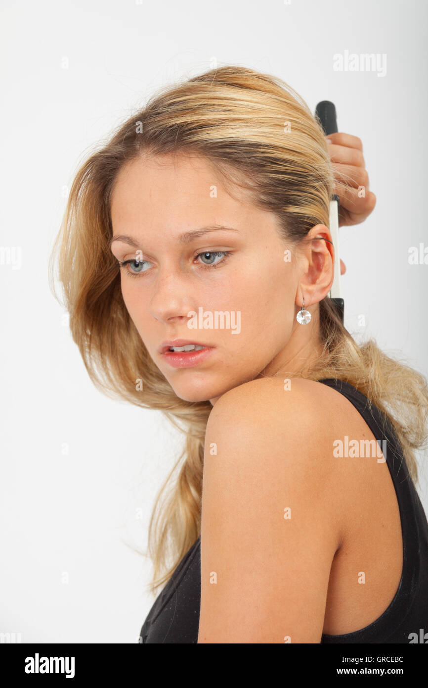 Young Woman Brushing Her Long Blond Hair Stock Photo Alamy
