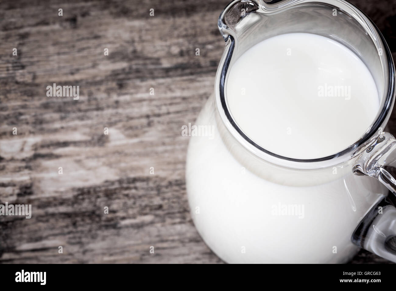 Jug of milk on wooden background Stock Photo