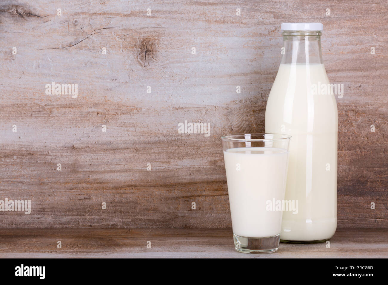 bottle and glass of milk on wooden background Stock Photo