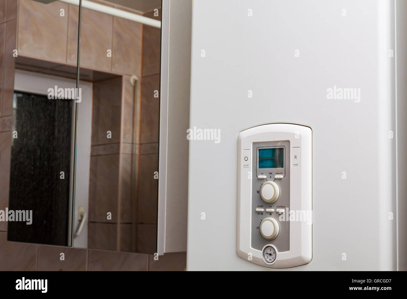 Control panel of DHW or central heating on combi boiler in restroom. Stock Photo