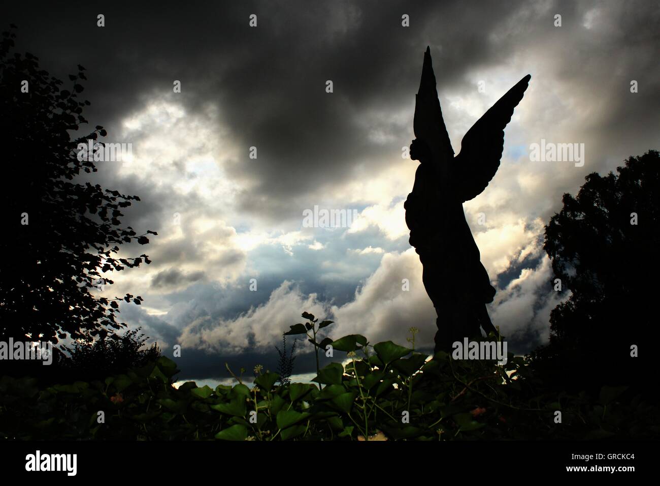 Angel Before Dramatic Clouds Scenery Stock Photo