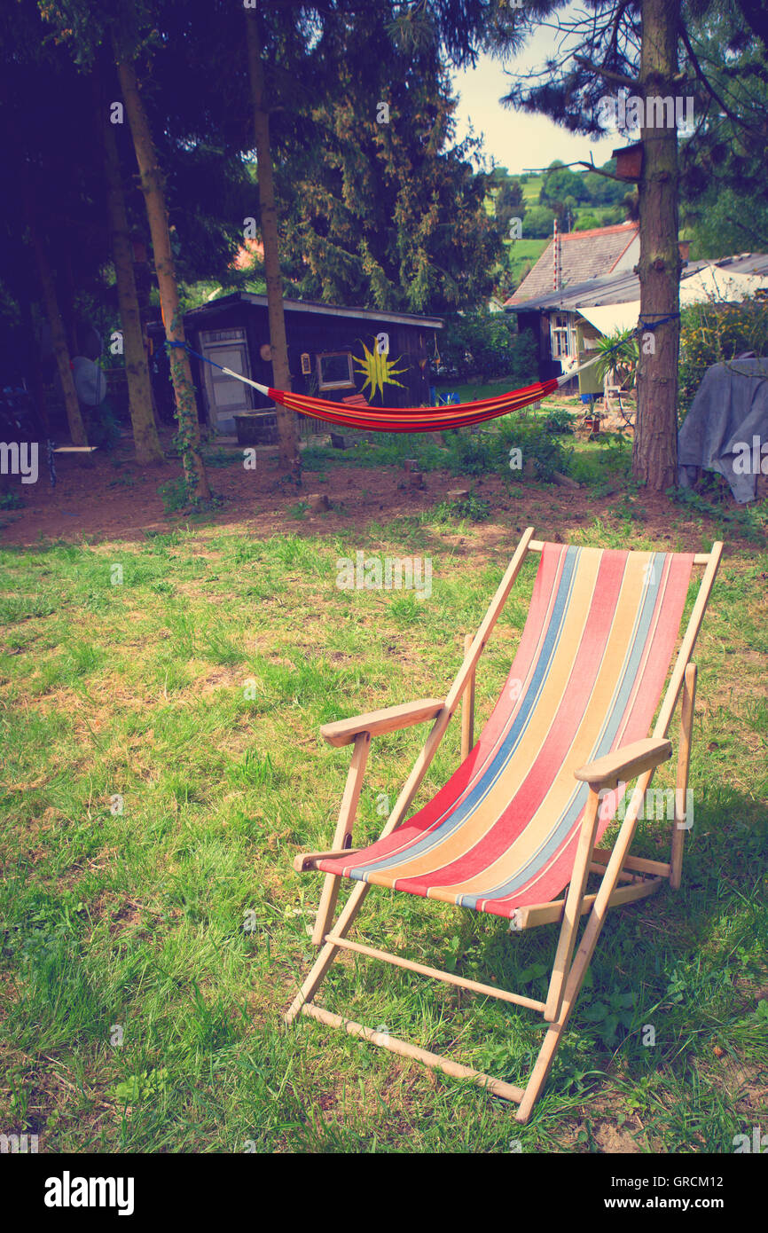 Old Deckchair In Country House Idyll Stock Photo