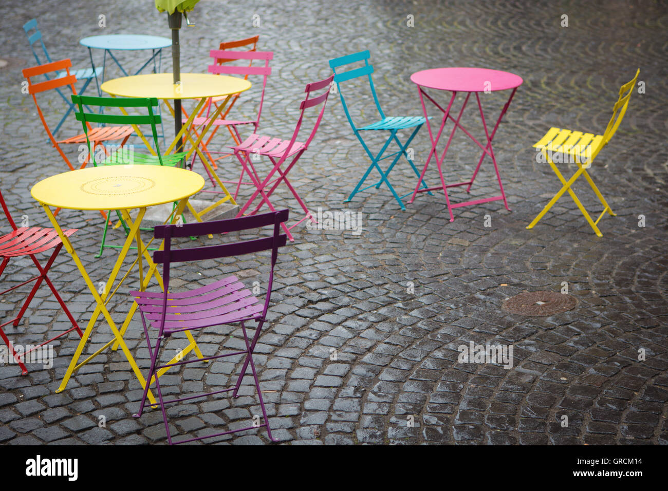 Sidewalk Cafe With Colorful Tables And Chairs Stock Photo