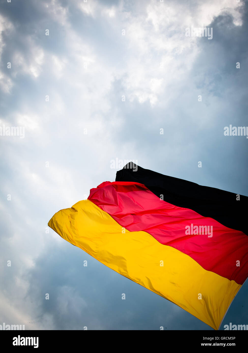 Germany Flag In Stormy Weather Stock Photo