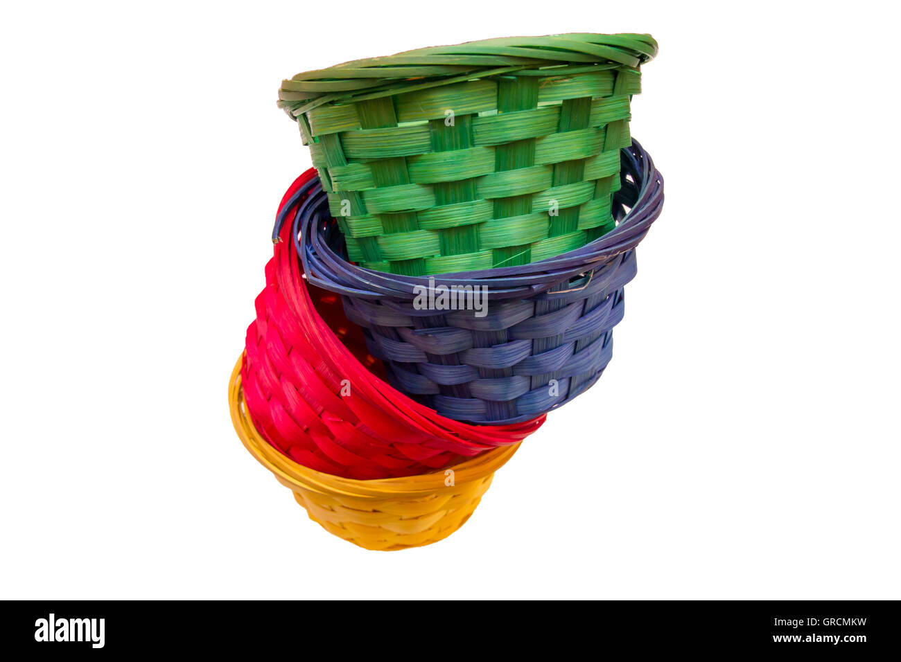 Colored wicker baskets one inside the other on a white background seen
