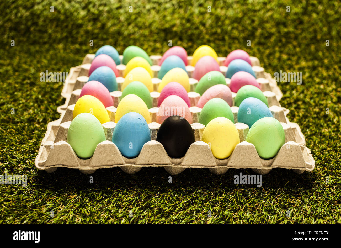 Colored Easter Eggs With One Black Egg Stock Photo Alamy