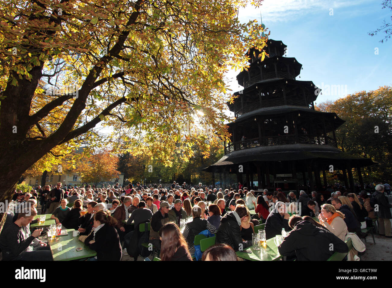 Warm And Sunny Fall Weather Led To Crowd At Beer Garden At Chinesischem Turm In Munich Stock Photo