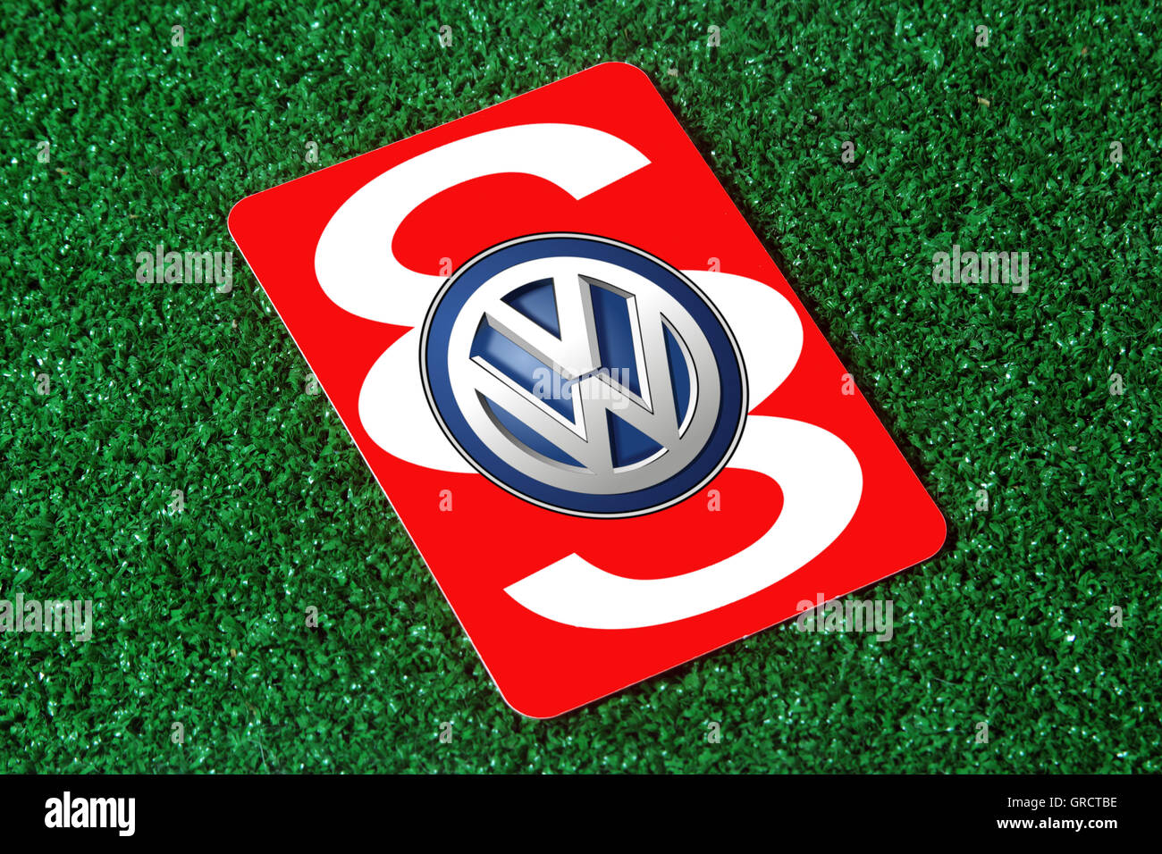 Red Card With Vw Sign And Paragraph On Green Turf Stock Photo