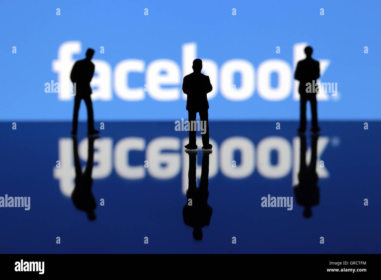 Facebook Sign With Silhouettes Of Miniature Figures Stock Photo
