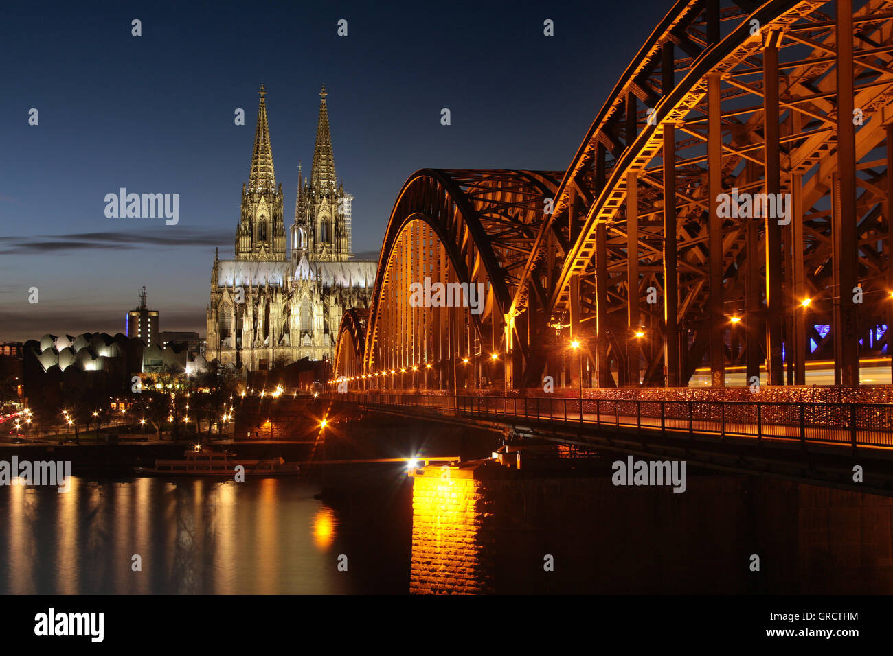 Cologne Cathedral With Railway Bridge At Dusk Stock Photo