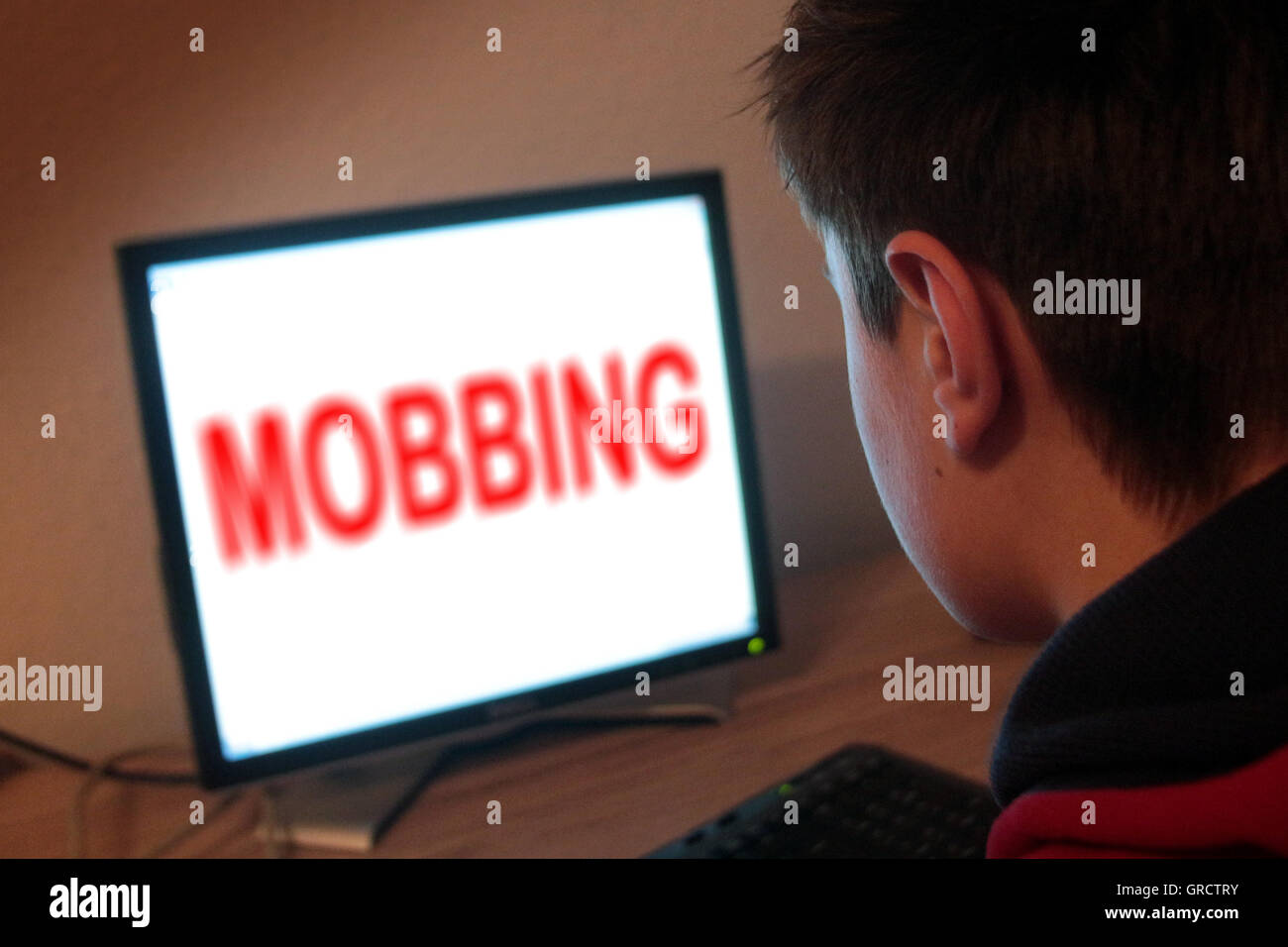 Word Mobbing On Flat Screen With Teenager Stock Photo