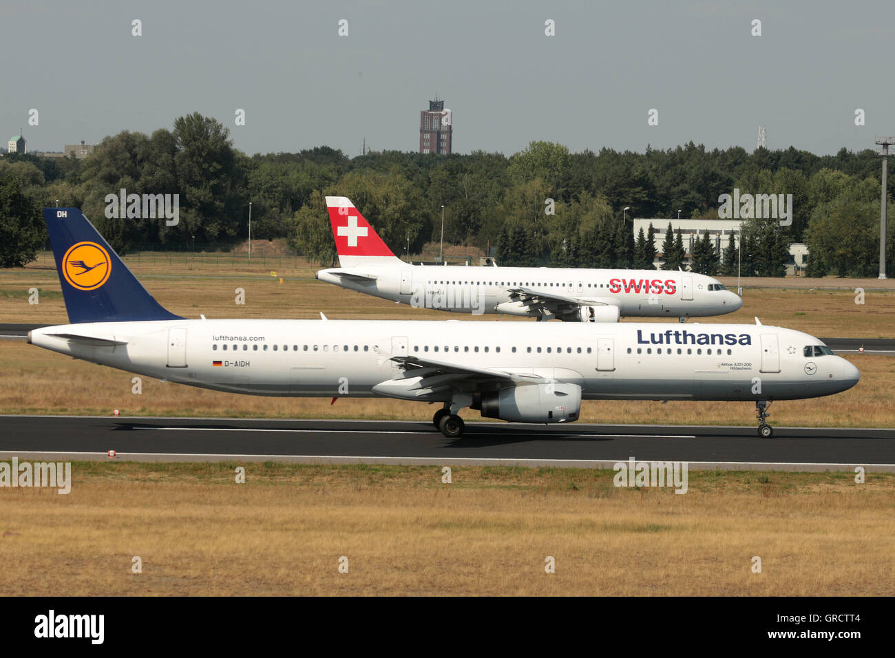 Swiss Airbus A319 With Registration Hb-Ijj And Lufthansa D-Aidh On Runway At Berlin Tegel Airport Txl Stock Photo