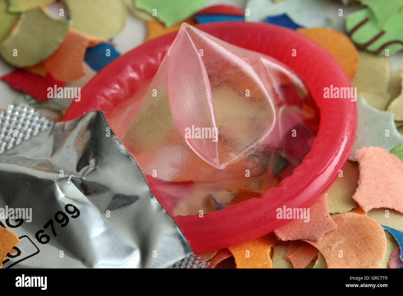 Safer Sex During Carnival And Mardi Gras Condom Between Confetti Stock Photo