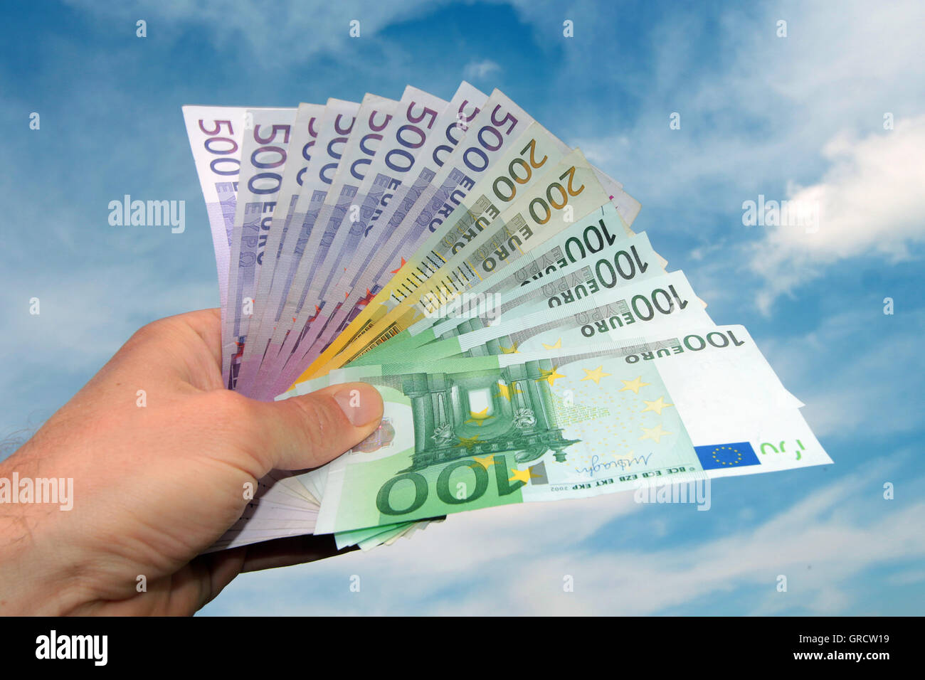 Hand Holding Bundle Of Euro Bills Stock Photo