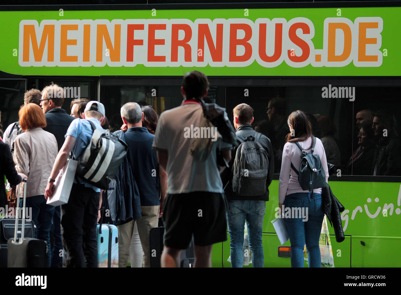 Long Distance Bus Meinfernbus With Silhouettes Of Waiting Travelers In Munich Stock Photo