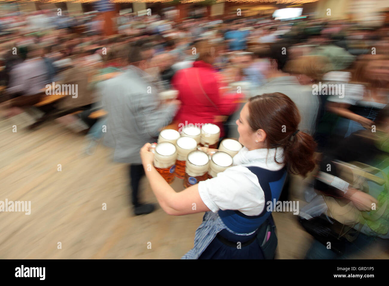 Waitress With Beer Kegs At Oktoberfest Stock Photo