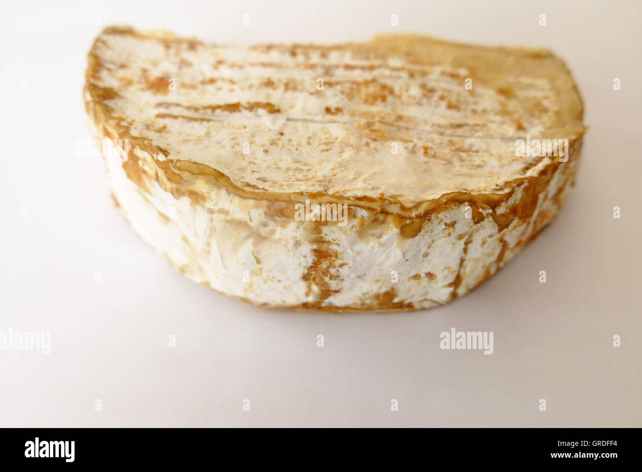 Overripe Soft Cheese, Slightly Scruffy, Isolated In White Background Stock Photo