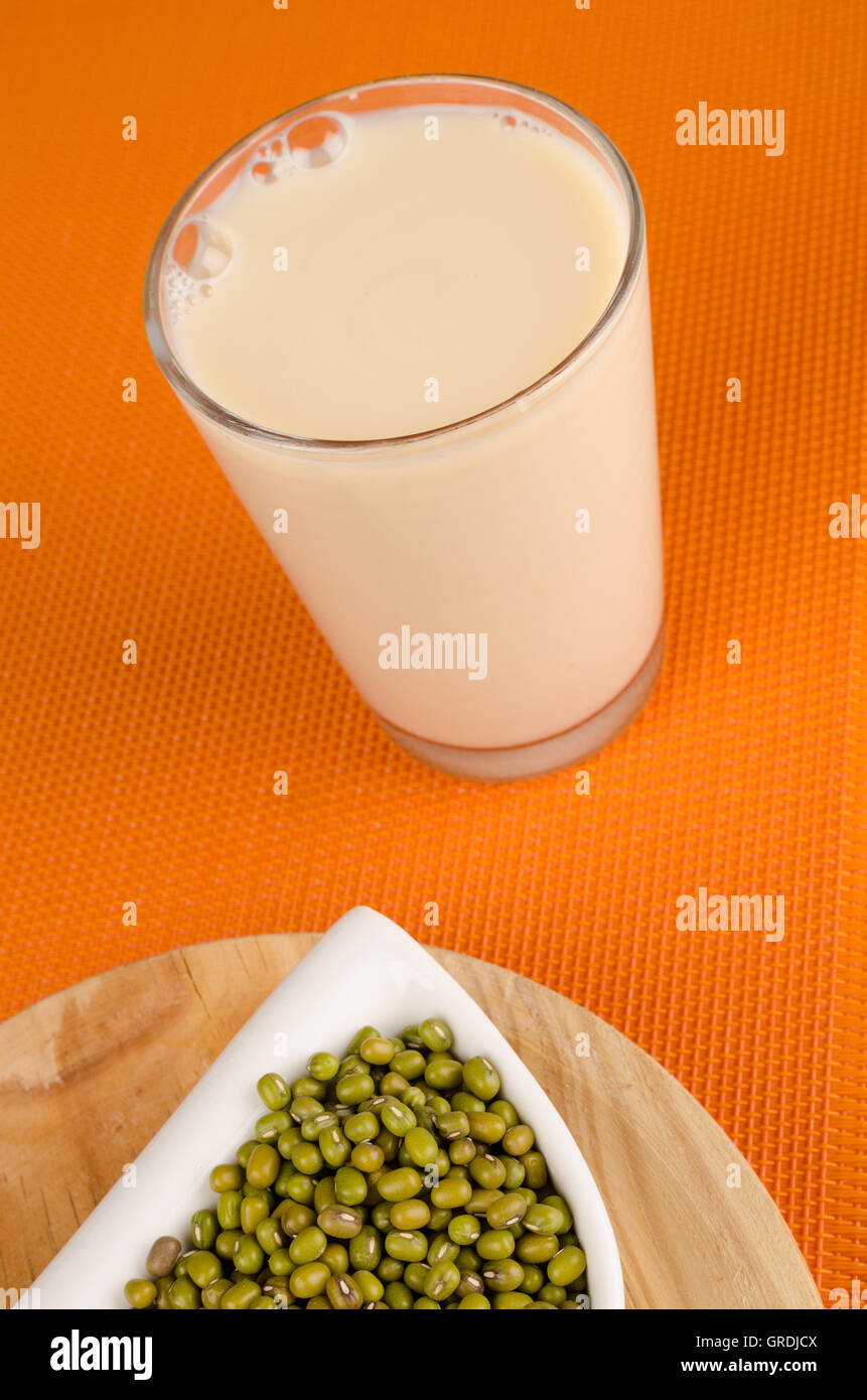 Glass of soy milk in a still life with raw beans Stock Photo Alamy
