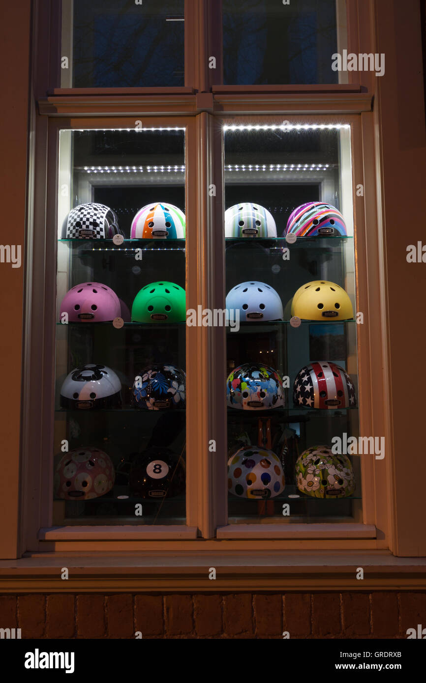 Various Bicycle Helmets In A Shop Window Stock Photo