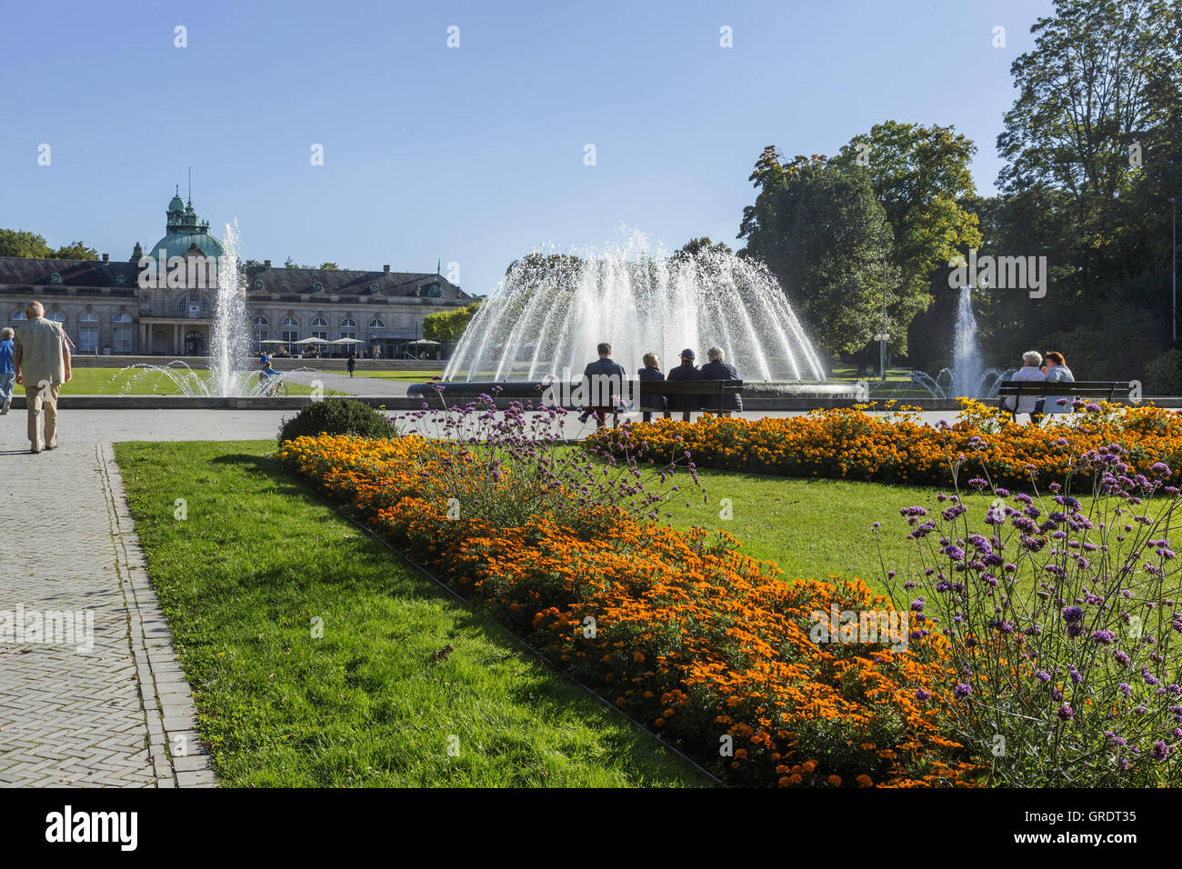 Flowerbeds, Fountains And Spa Guests In The Kurpark Bad Oeynhausen Stock Photo