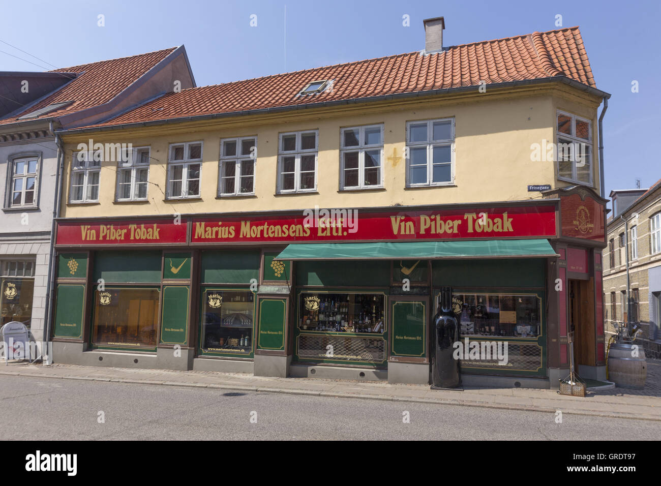 Corner Shop With A Distinctive Color In Downtown Nykobing Denmark Stock Photo