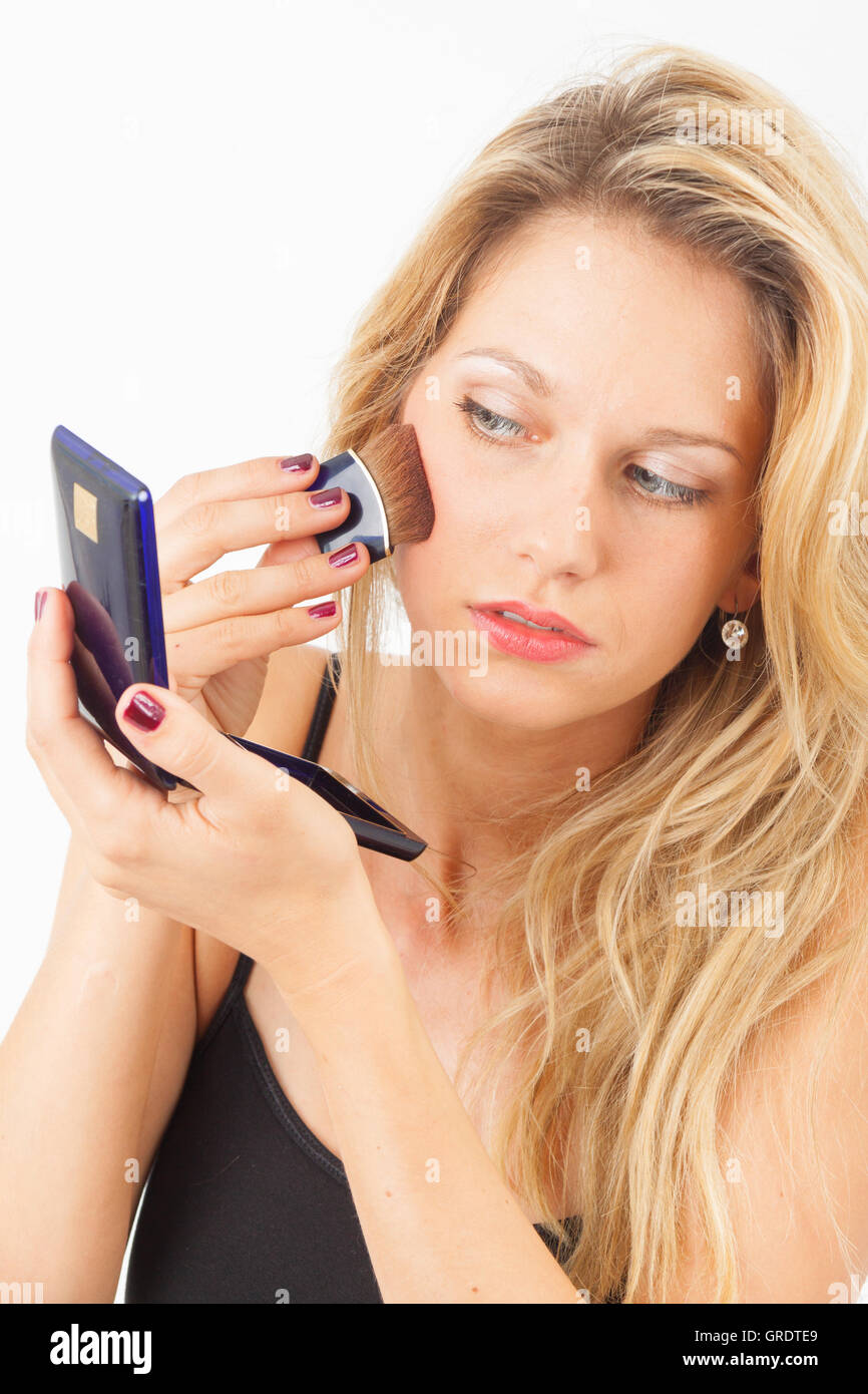 Young Woman Putting Rouge With A Wide Brush On Stock Photo