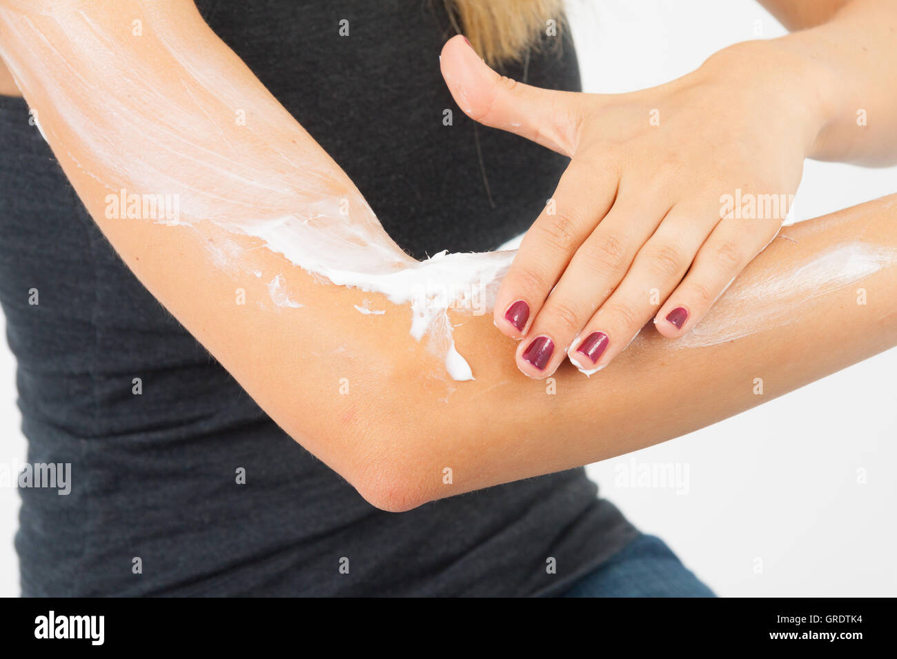 Woman putting lotion on arm hires stock photography and images Alamy