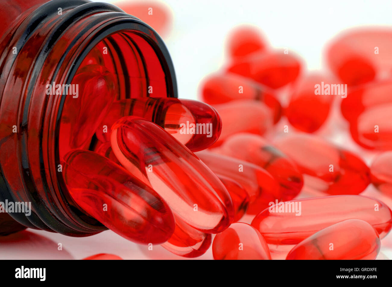 Red soft gelatin capsule use in pharmaceutical manufacturing for contain oily drug and nutritional supplement like vitamin A,D,E Stock Photo