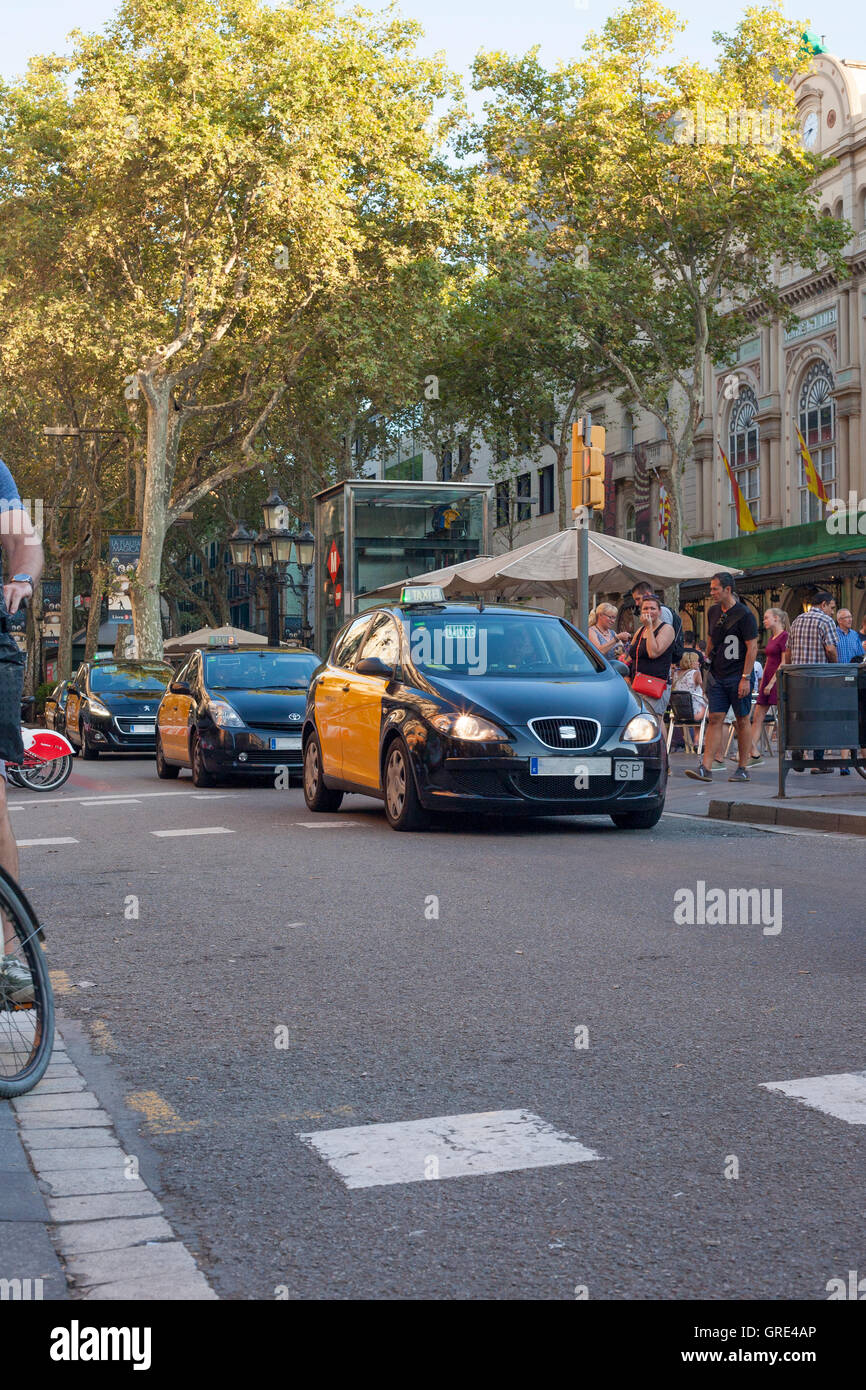 Barcelona, Spain - July 23, 2016: Taxi car goes by Ramblas avenue in Barcelona City Stock Photo