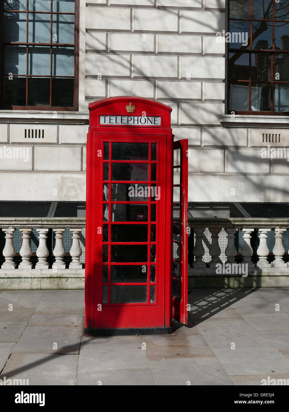 English, Red Telephone Cab On Pavement, London Stock Photo