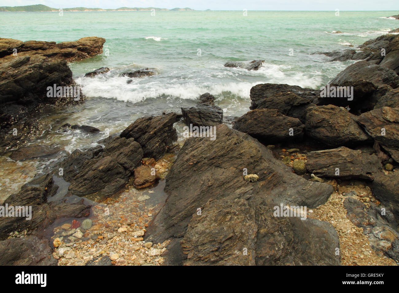 sea waves hitting round rocks and splashing Stock Photo - Alamy