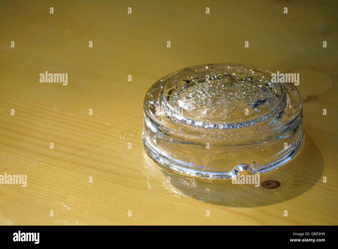 Upside Down Empty, Wet Glass Ashtray On Wooden Table Stock Photo Alamy