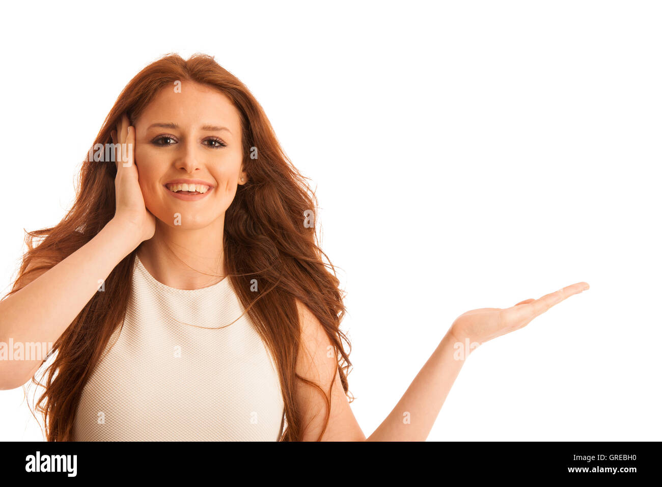 Business woman holds hand and points to copyspace as she would hold a product for commercial isolated over white background Stock Photo