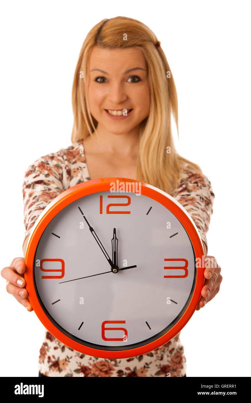 Cute blond woman with a big orange clock gesturing being late isolated over white Stock Photo