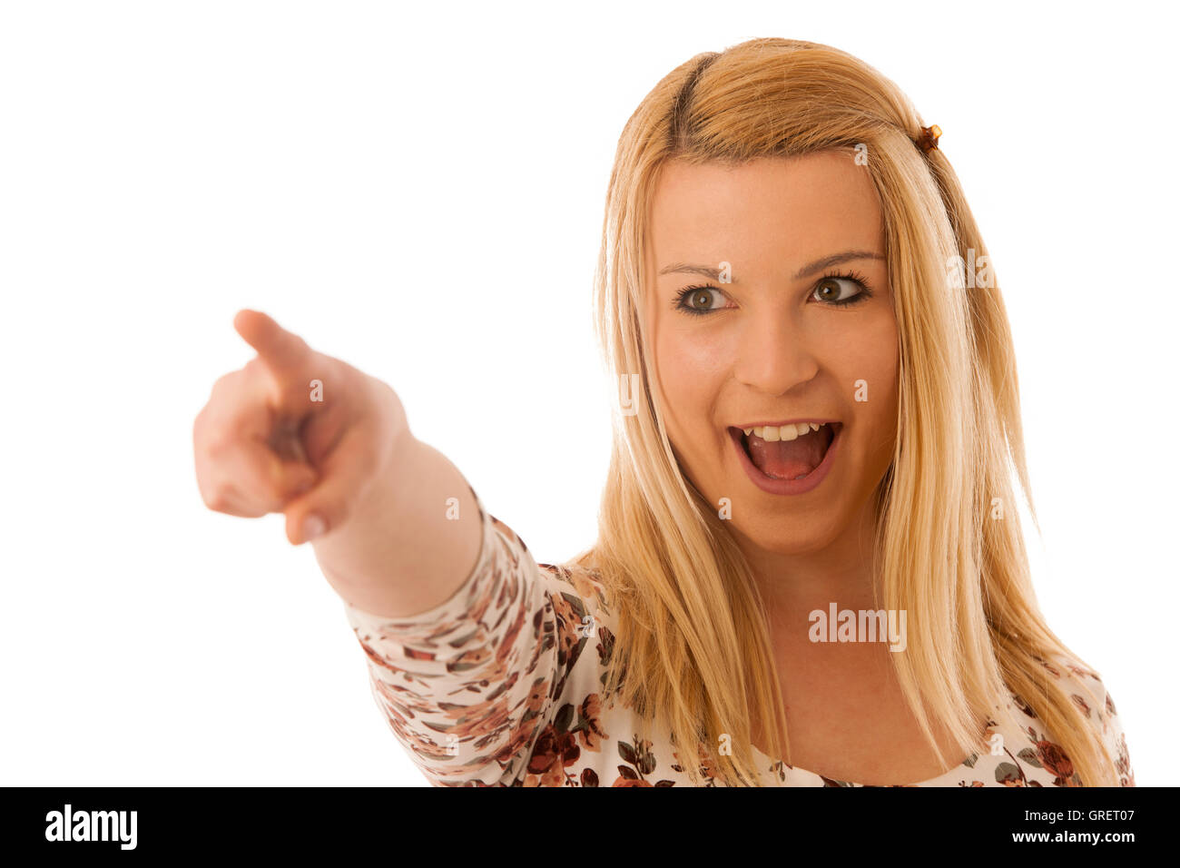 Cute blond woman pointing into copy space as she is showing a product for commercial Stock Photo